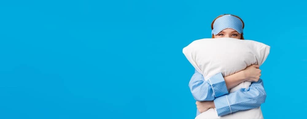 Woman with a pillow for good night sleep tight tips