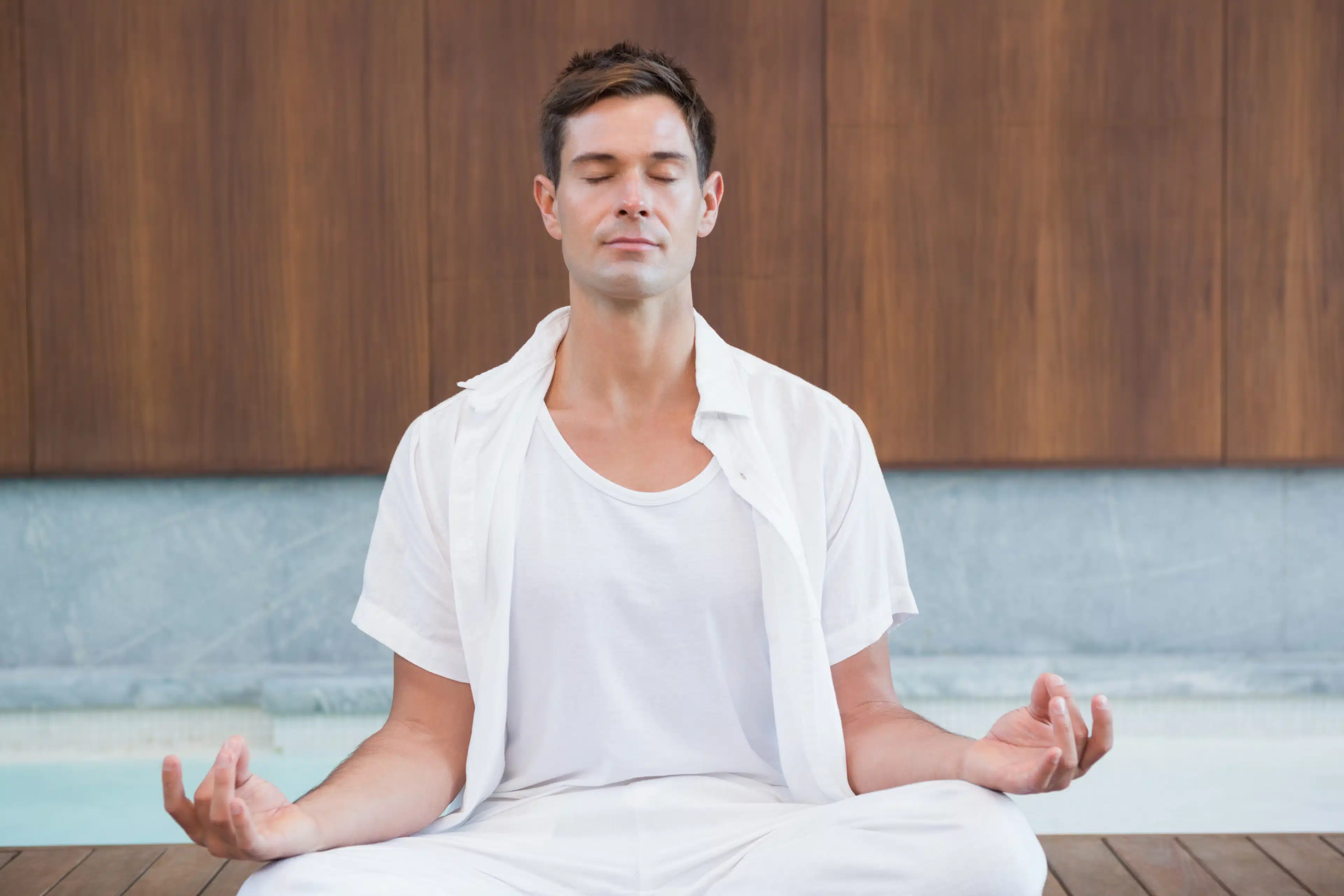 What is health, Handsome man in white meditating in lotus pose in health spa, cortex of lifestyle