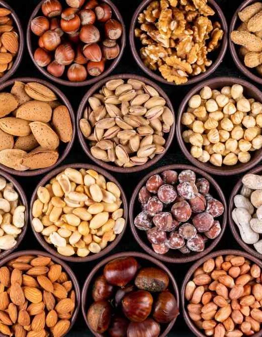 Variety of nuts and oilseeds, walnuts, almond, groundnut, garden cress seeds, gingelly seeds