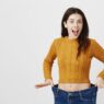 Woman showing loose jeans and weight loss