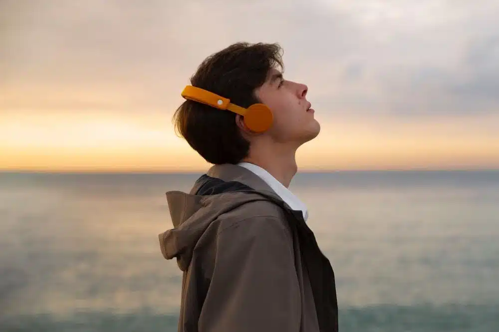 Man near sea with headphones, Living life on autopilot