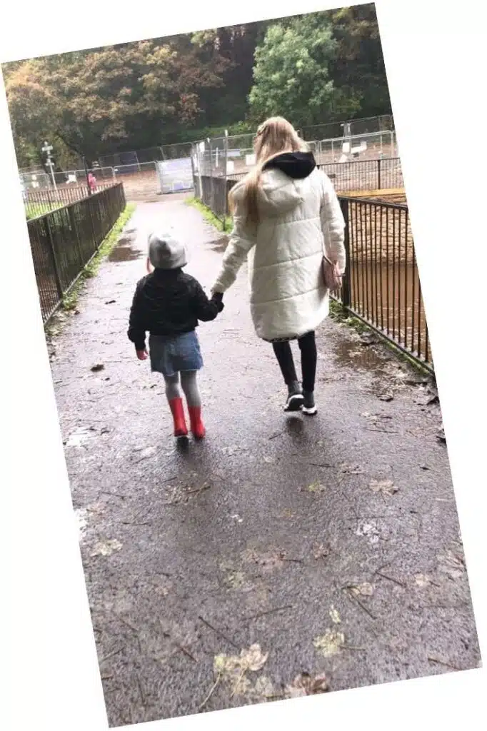 Woman walking with a child holding hands, Women and Girls in Sports