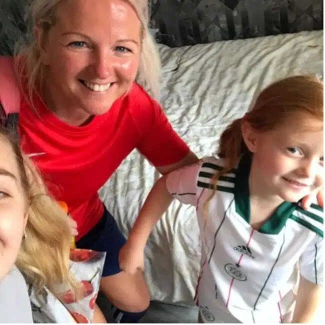 Woman with 2 girls in sports dress