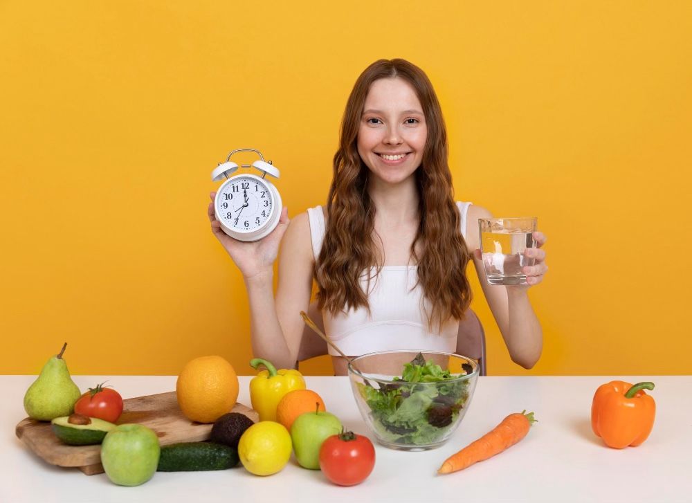 Woman showing clock, water, food for intermittent fasting, to fast or not to fast, dry fasting vs wet fasting, 5:2 fasting