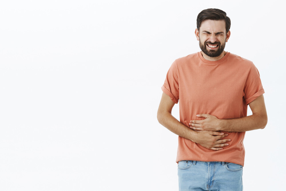 Man having stomach pain, gut microbiome and pain