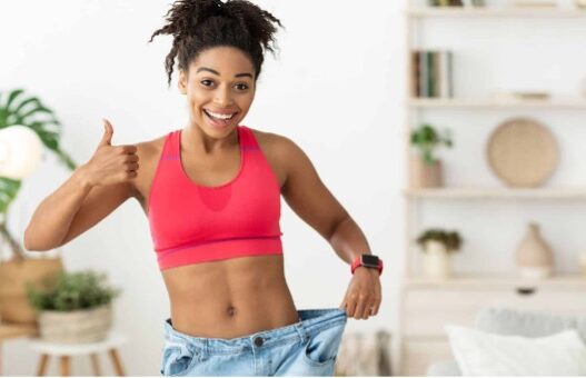 Woman happily showing weight loss from waist in Plenity Reviews of Gelesis 100