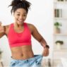 Woman happily showing weight loss from waist in Plenity Reviews of Gelesis 100