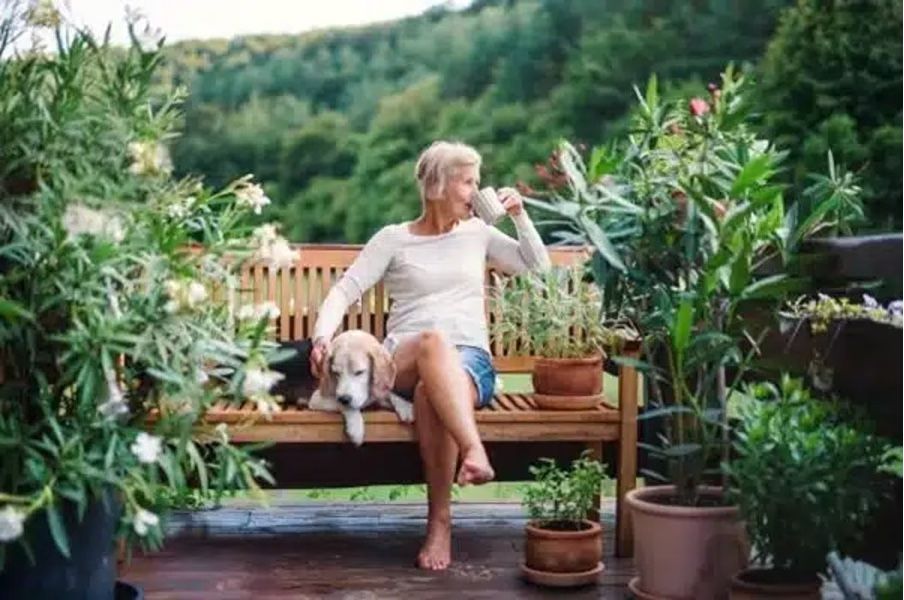 Woman drinking coffee in park, healthy lifestyle tips, why healthy lifestyle is a wise financial investment