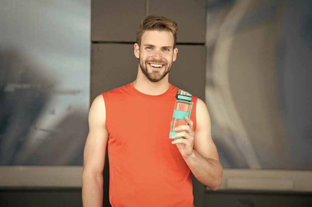 Man drinking Alani Nu Energy Drink