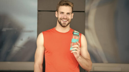 Man drinking Alani Nu Energy Drink
