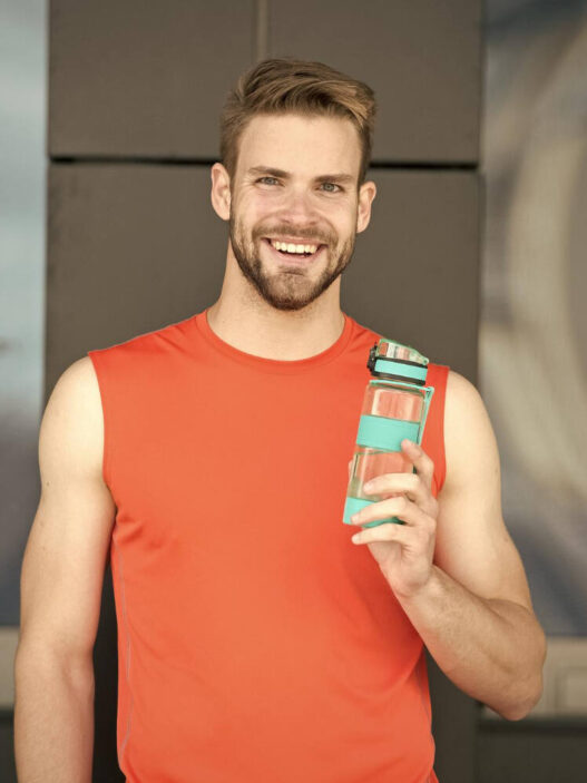 Man drinking Alani Nu Energy Drink