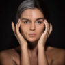 woman showing aged and clean face side, tretinoin vs retinol