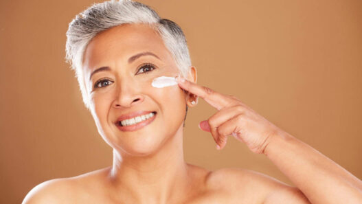 Woman applying Hibiscus and Honey Firming cream by NuSkin reviews, ageLOC dermatic effects