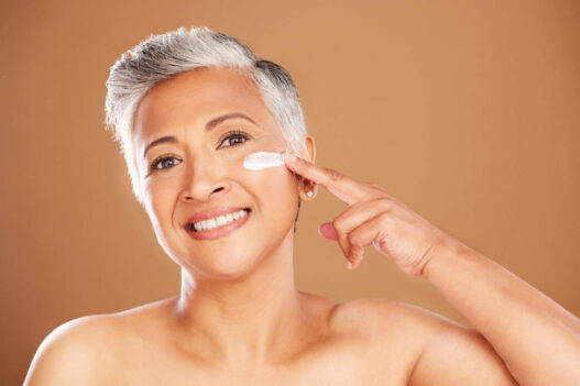 Woman applying Hibiscus and Honey Firming cream by NuSkin reviews, ageLOC dermatic effects