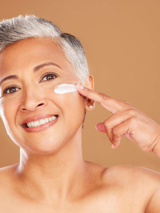 Woman applying Hibiscus and Honey Firming cream by NuSkin reviews, ageLOC dermatic effects