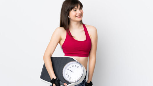 woman holding weighing machine in phenq reviews blog