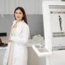 dentist with laptop and digital signage