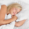 Woman sleeping peacefully on bed