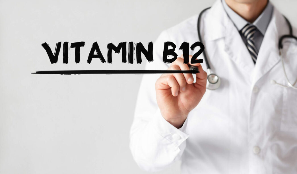Doctor writing Vitamin B12