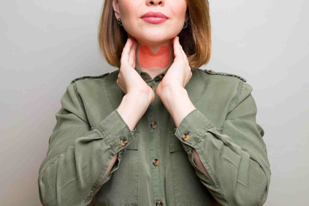 woman showing thyroid gland, thyroid health and weight