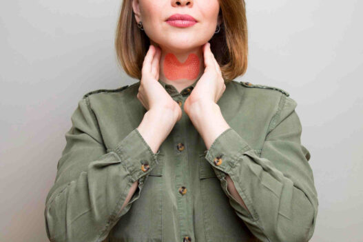 woman showing thyroid gland, thyroid health and weight