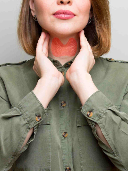 woman showing thyroid gland, thyroid health and weight