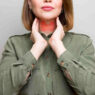 woman showing thyroid gland, thyroid health and weight