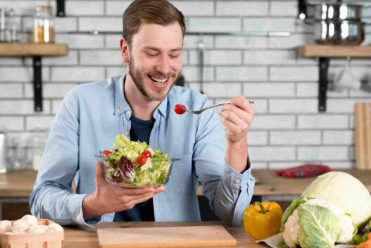 nutritional strategies, man eating bowl of veggies, nutrition male fertility