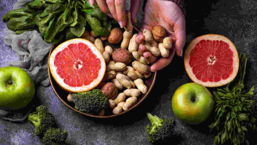 Nutritionism, healthy vegetarian food with orange, peanut, broccoli, apple