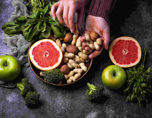Nutritionism, healthy vegetarian food with orange, peanut, broccoli, apple