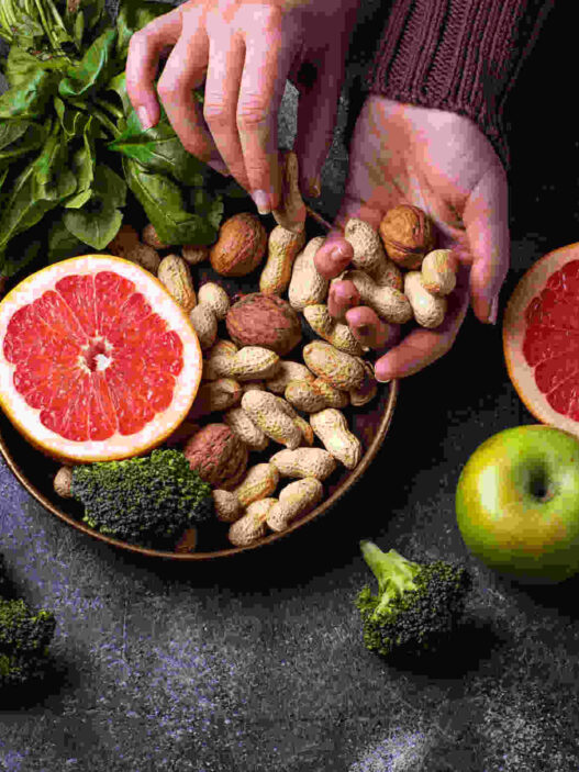 Nutritionism, healthy vegetarian food with orange, peanut, broccoli, apple