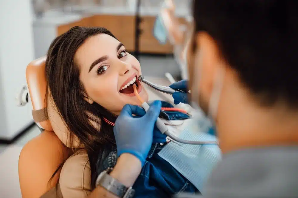 Woman on dentist chair with a dentist, how to improve your oral health