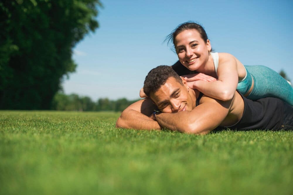 Man and woman lying in park Self-care, Self-exhaustion, Wellness Fatigue