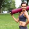 Woman with fitness mat, back to the grind