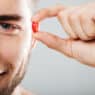 Man happy showing capsule Mitolyn in mitolyn reviews for mitochondrial health