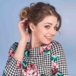 Woman showing Daith piercings jewelry with a smile, daith piercing and migraine